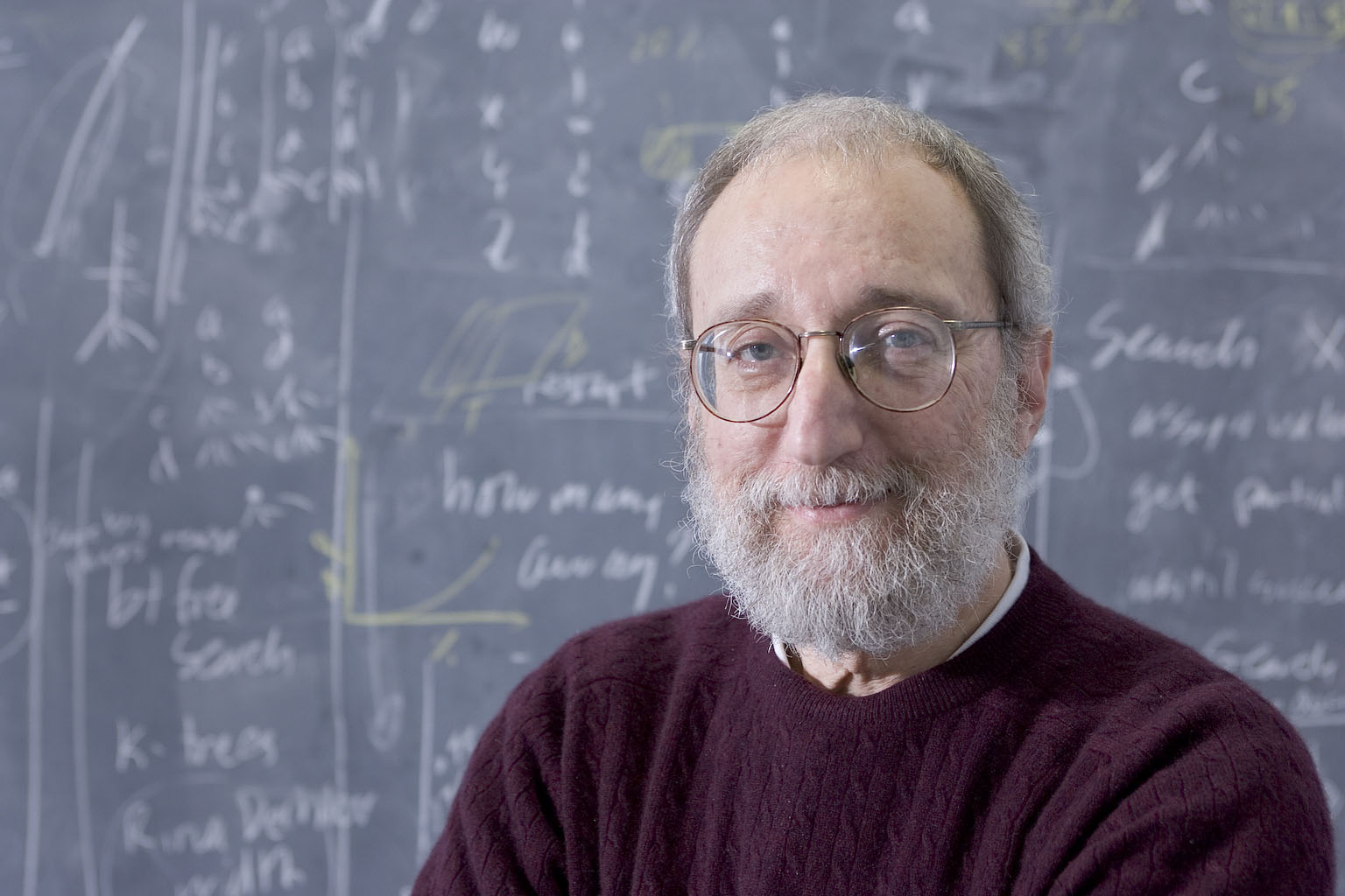 Professor Eugene Freuder -Cork Constraint Computation Centre -- in front of a chalkboard